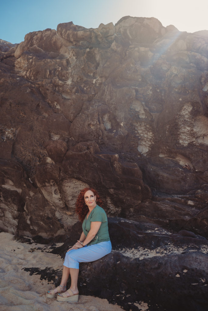 Allyson Chavez sitting next to the seaside