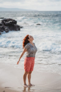 Allyson Chavez on the beach feeling the wind
